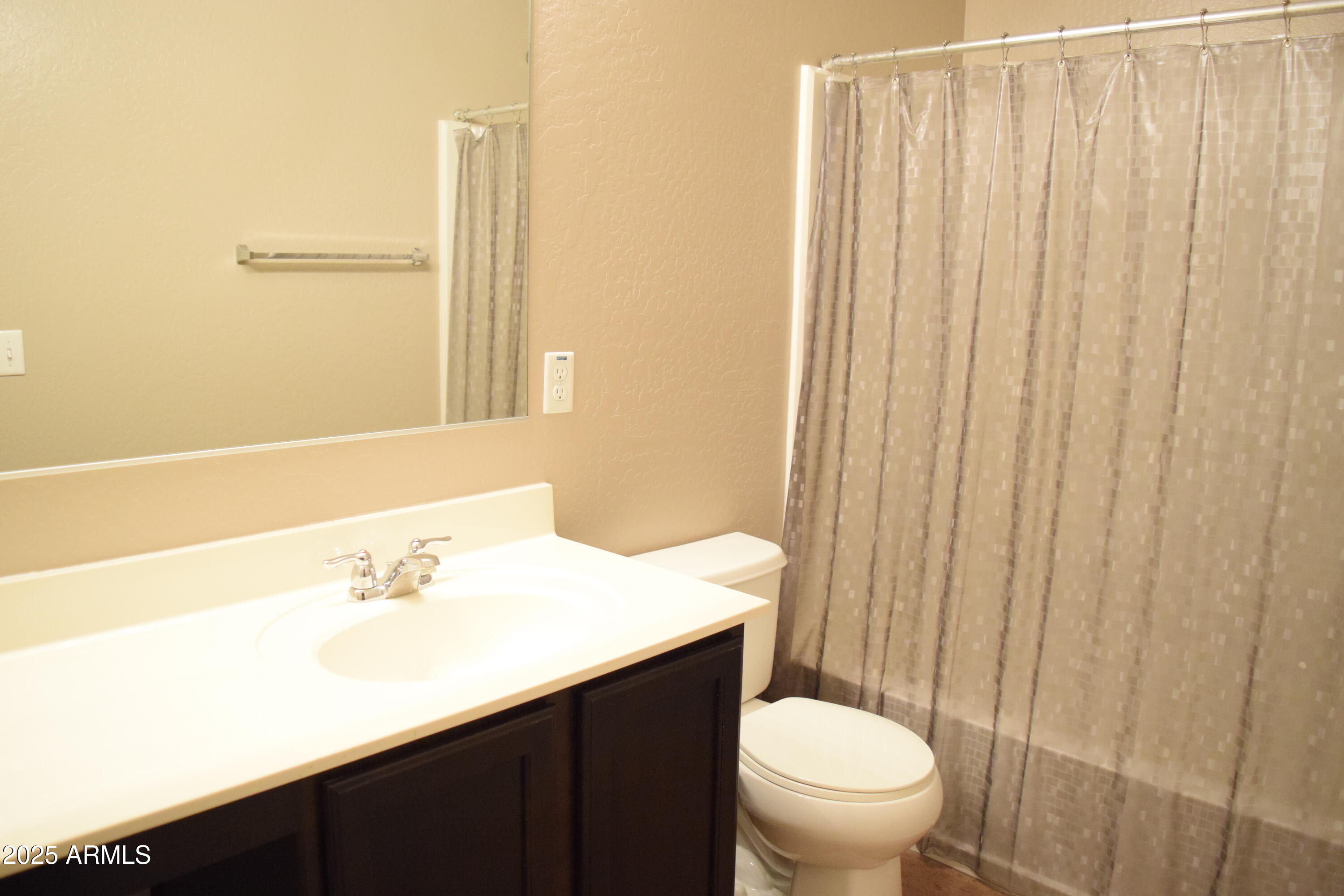 1250 South Rialto, Unit 24 Mesa, AZ 85209 - Photo 12 of 25 a bathroom with a sink a toilet and shower curtain