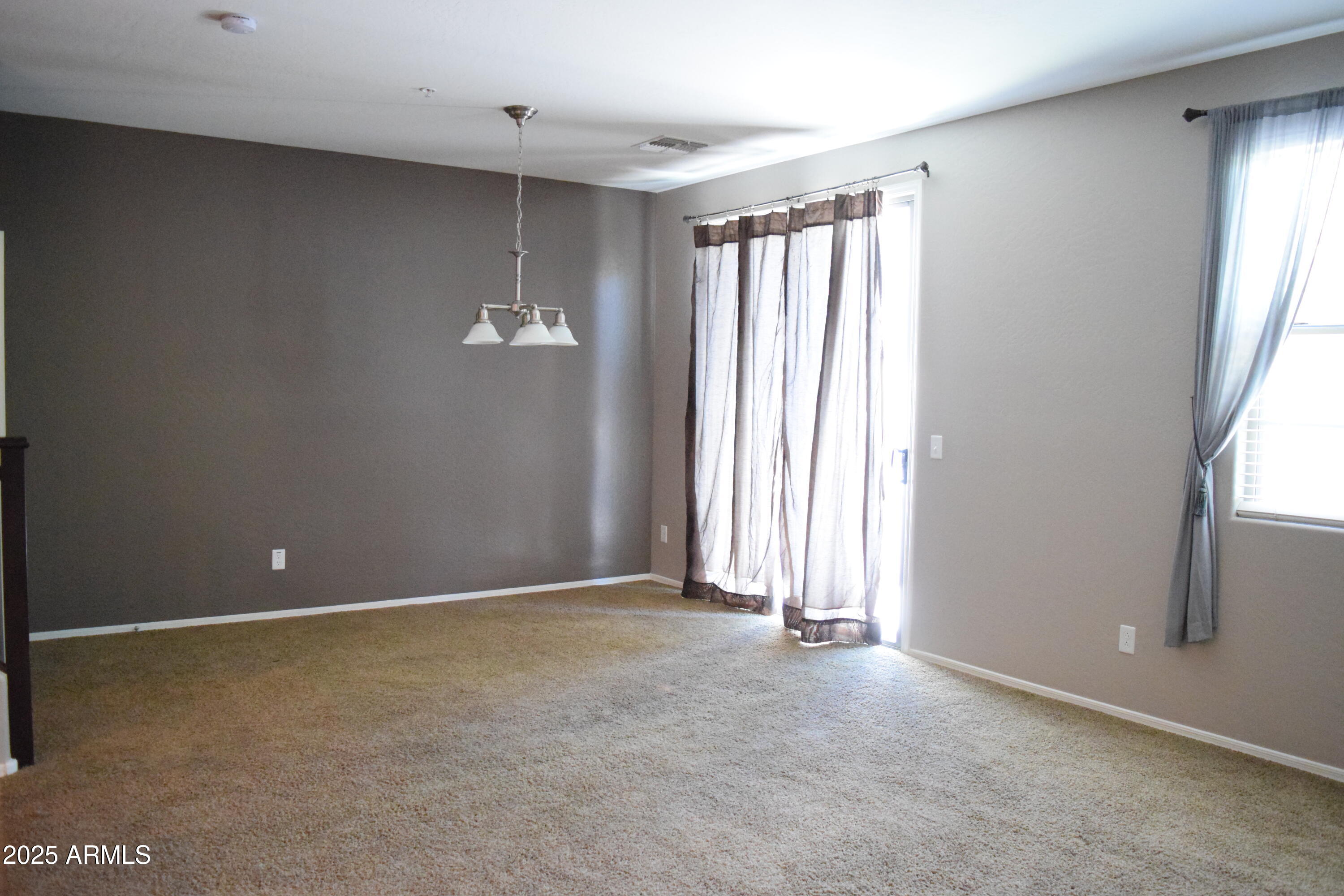 1250 South Rialto, Unit 24 Mesa, AZ 85209 - Photo 8 of 25 an empty room with windows and closet