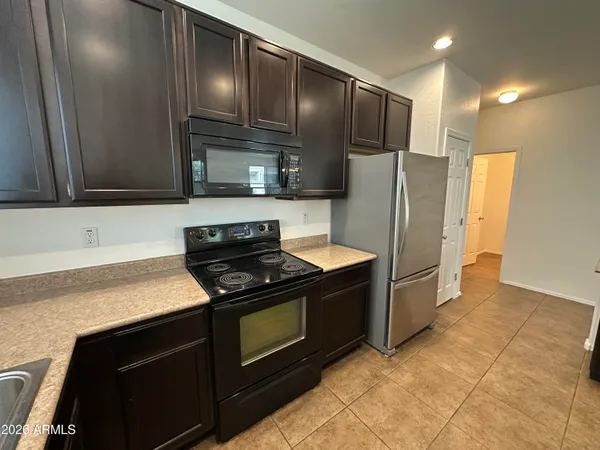 a view of a refrigerator in kitchen