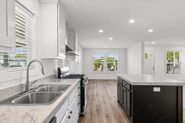 a kitchen with a sink and a wooden floor