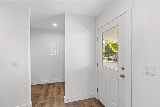 a view of an empty room with closet and a window