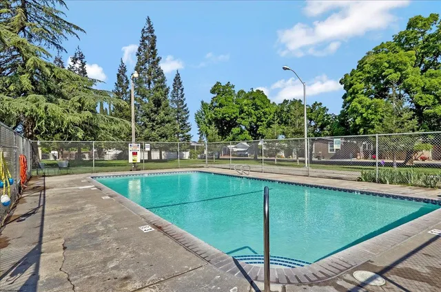 a view of swimming pool with a bench in the patio