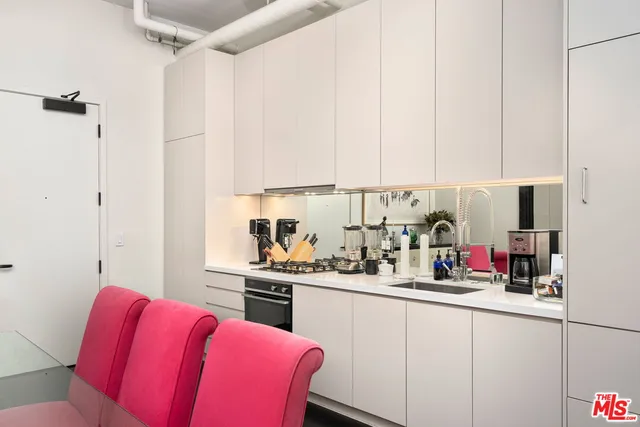 a kitchen with stainless steel appliances granite countertop a sink and cabinets