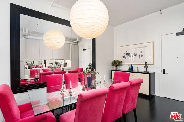 a living room with furniture and a large mirror