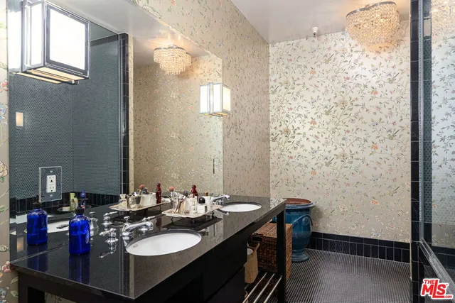 a bathroom with a sink vanity granite and a mirror