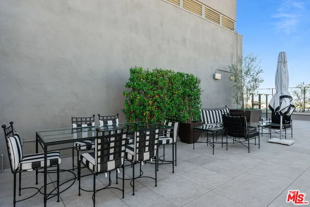 a view of a chairs and table in patio