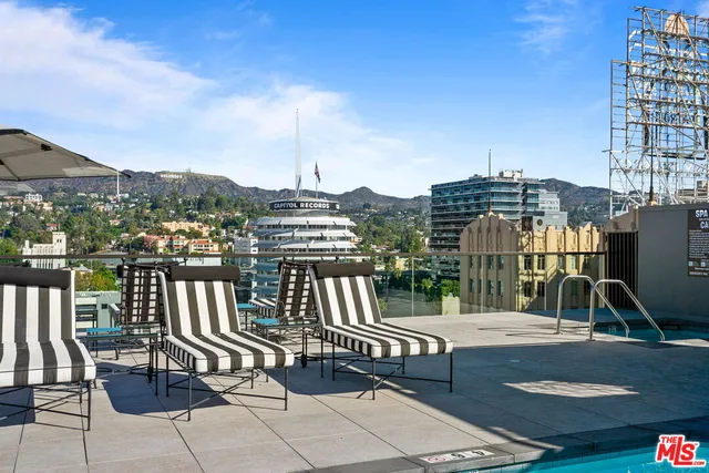a view of a balcony with two chairs and a potted plant