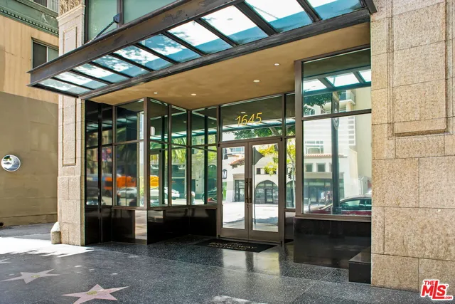 a building outdoor space with patio furniture and garden