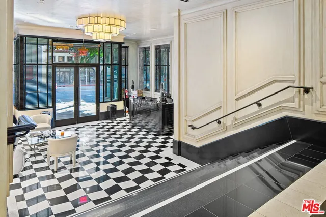 a very nice looking room with a large window and chandelier