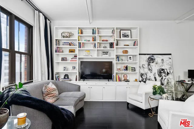 a living room with furniture cabinets and a flat screen tv
