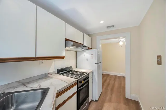 a kitchen with a stove and a refrigerator