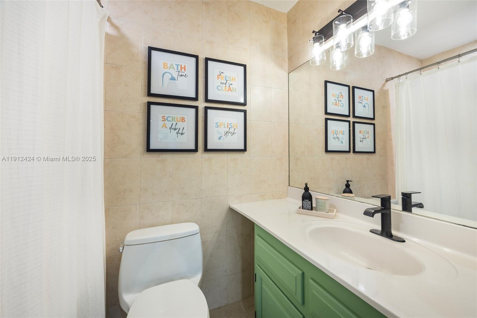 11537 Southwest 64th Street, Unit A83 Miami, FL 33173 - Photo 14 of 24 a bathroom with a toilet sink and mirror