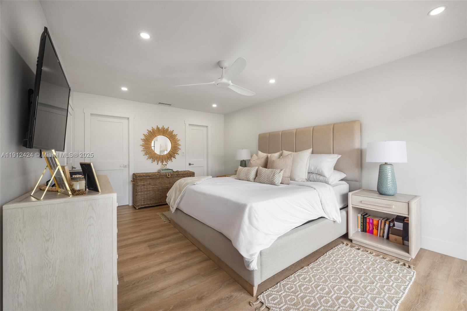 11537 Southwest 64th Street, Unit A83 Miami, FL 33173 - Photo 16 of 24 a bed room with a bed and a flat screen tv