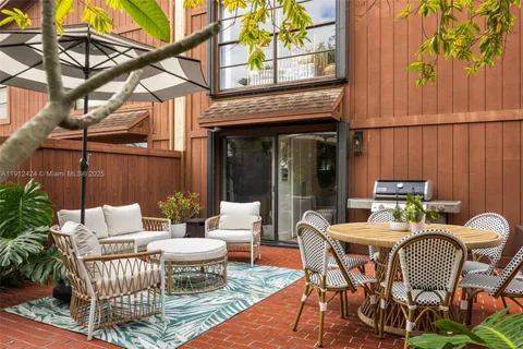 a view of a patio with a table and chairs