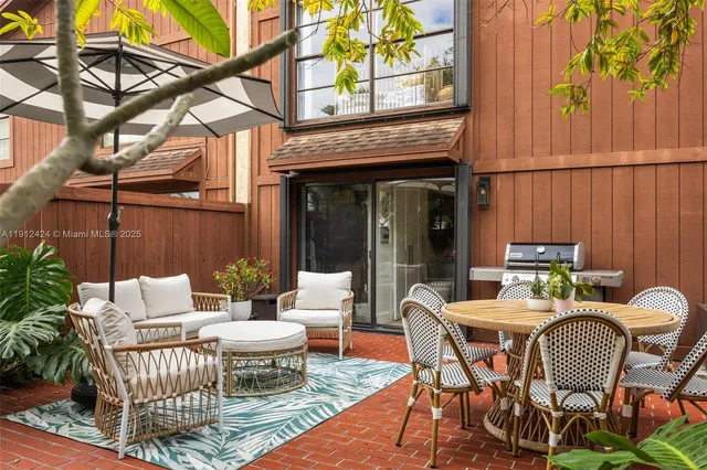 a view of a patio with a table and chairs