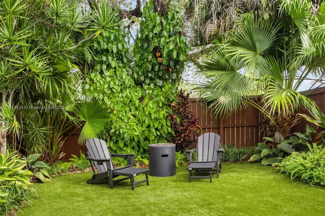 a garden with a bench and some plants