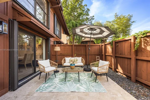 a backyard of a house with a fountain table and chairs