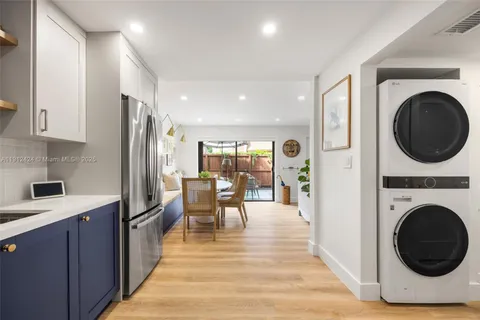 a view of a kitchen with dining table appliances and wooden floor