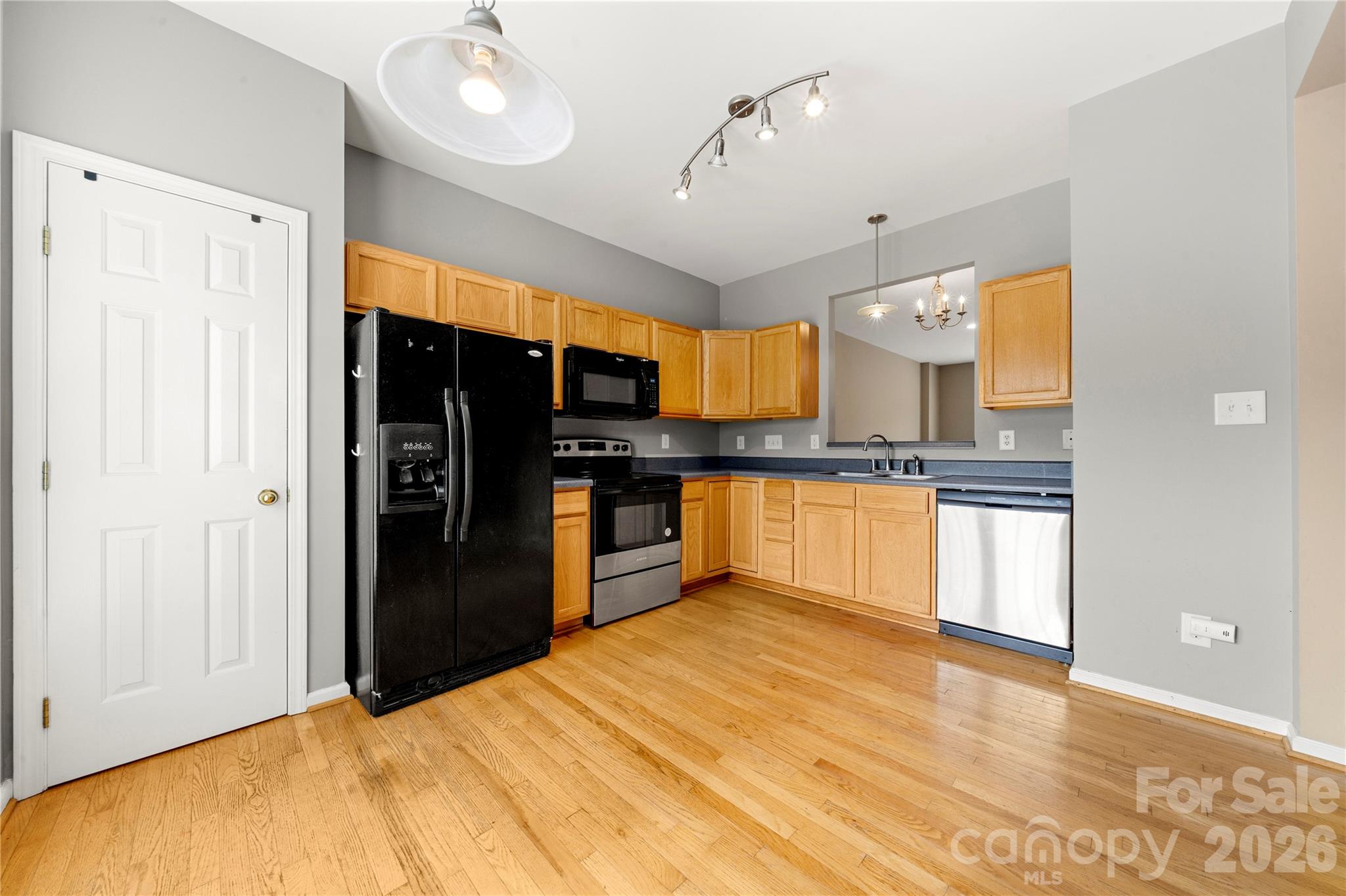 10213 Garrett Grigg Road Charlotte, NC 28262 - Photo 11 of 30 a kitchen with stainless steel appliances kitchen island granite countertop a refrigerator and a sink