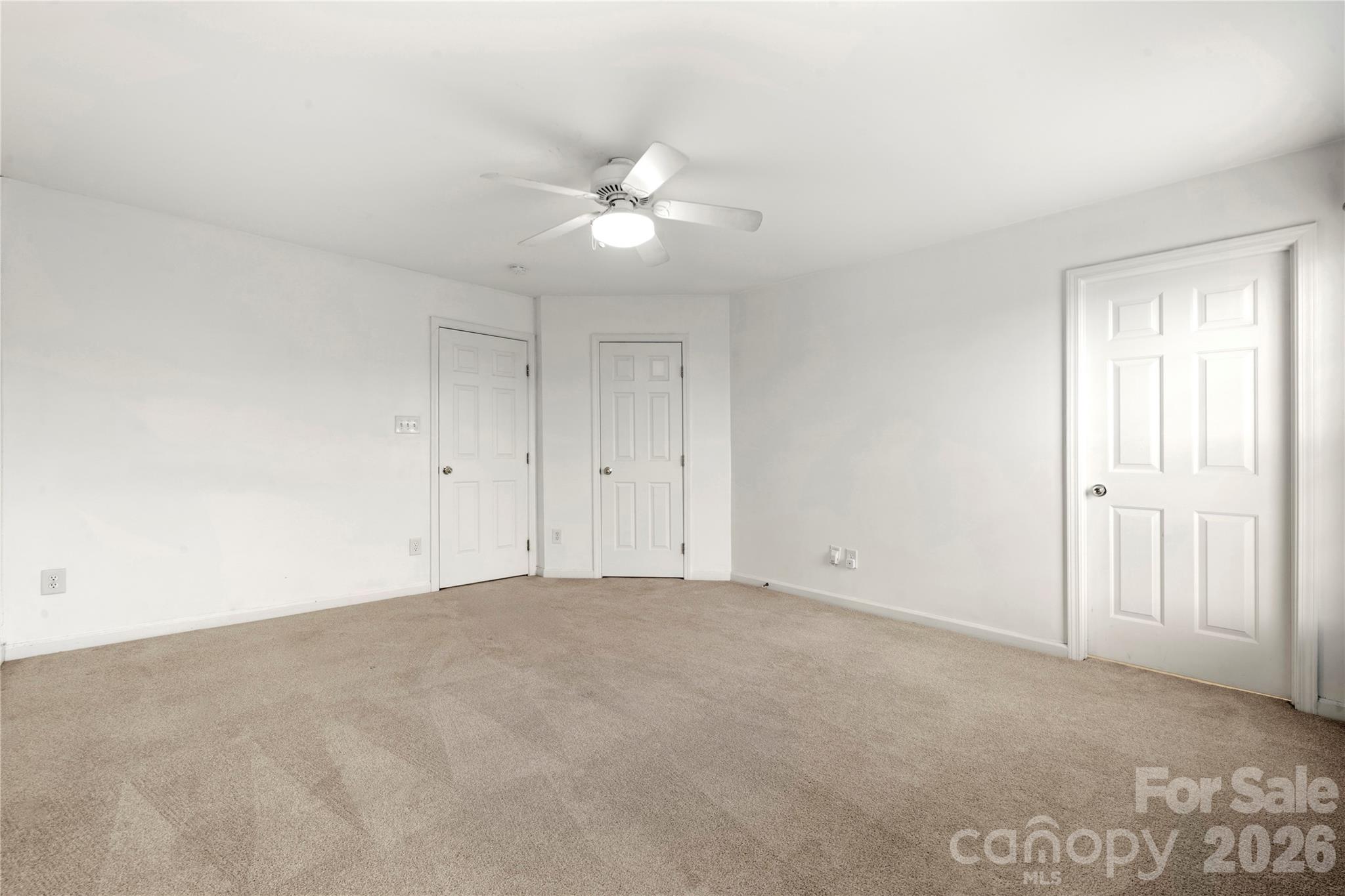 10213 Garrett Grigg Road Charlotte, NC 28262 - Photo 17 of 32 a view of an empty room with a ceiling fan