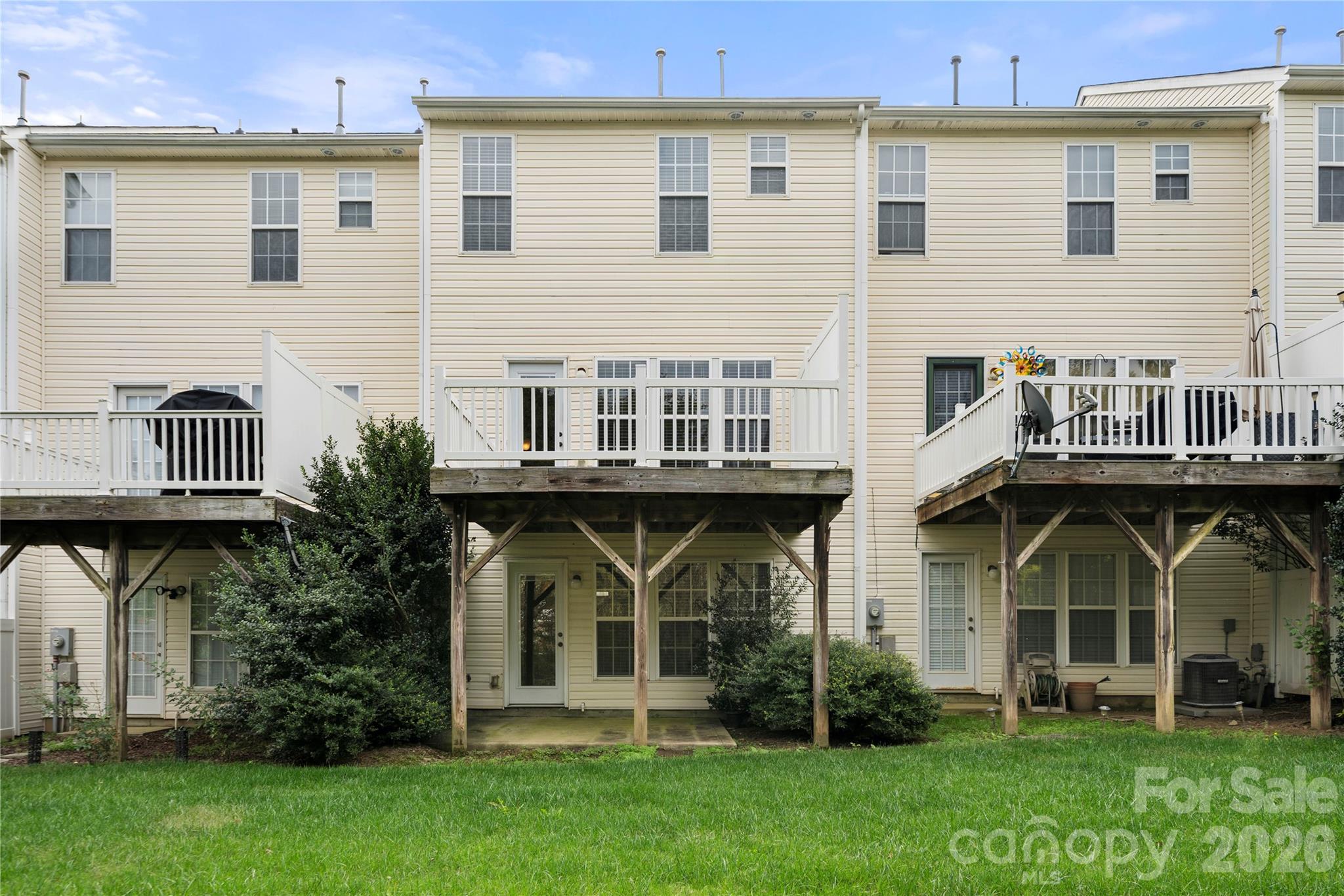 10213 Garrett Grigg Road Charlotte, NC 28262 - Photo 31 of 32 a view of a yard with large trees and a wooden deck