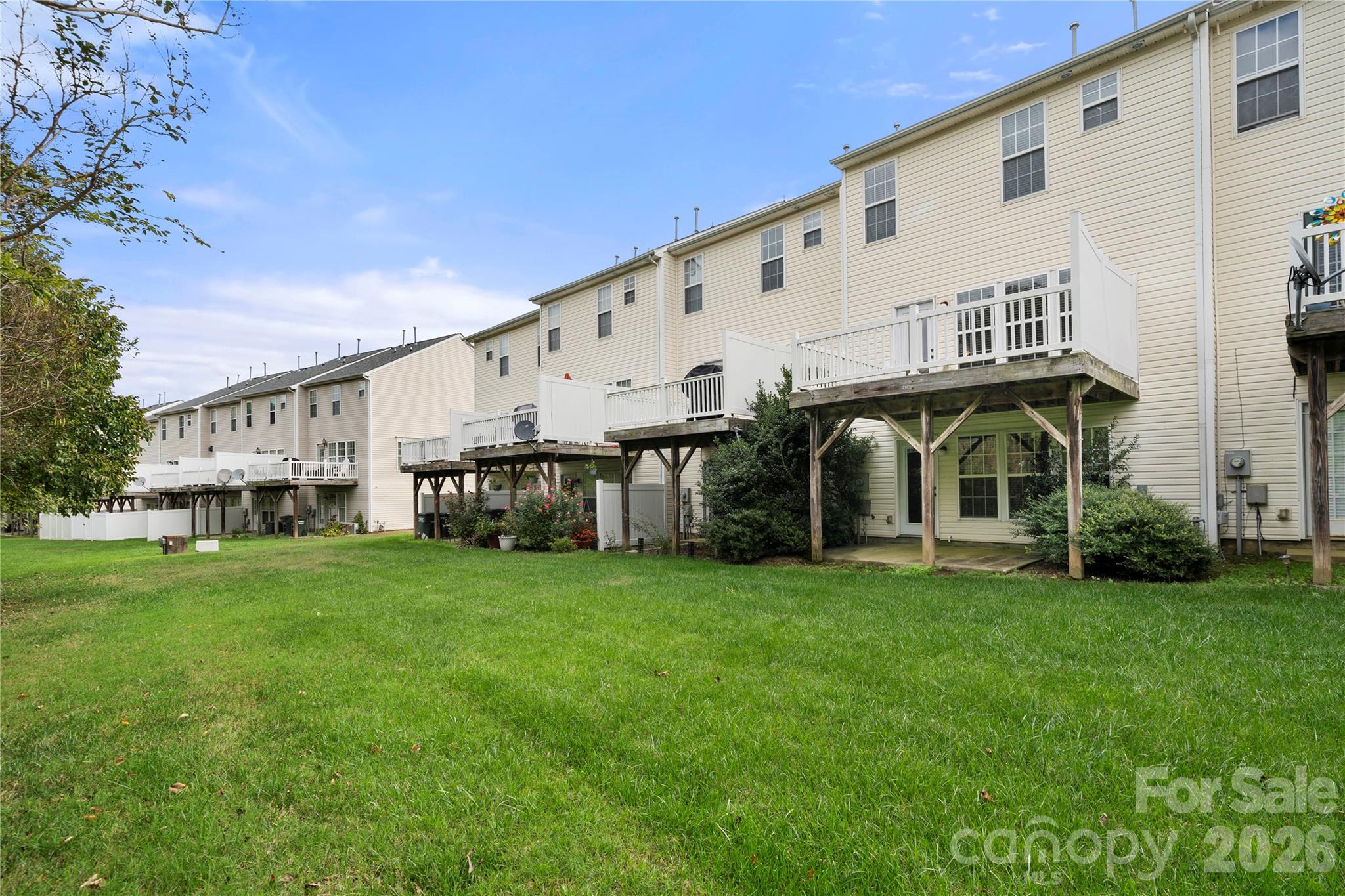 10213 Garrett Grigg Road Charlotte, NC 28262 - Photo 32 of 32 a view of a big house with a big yard and large trees