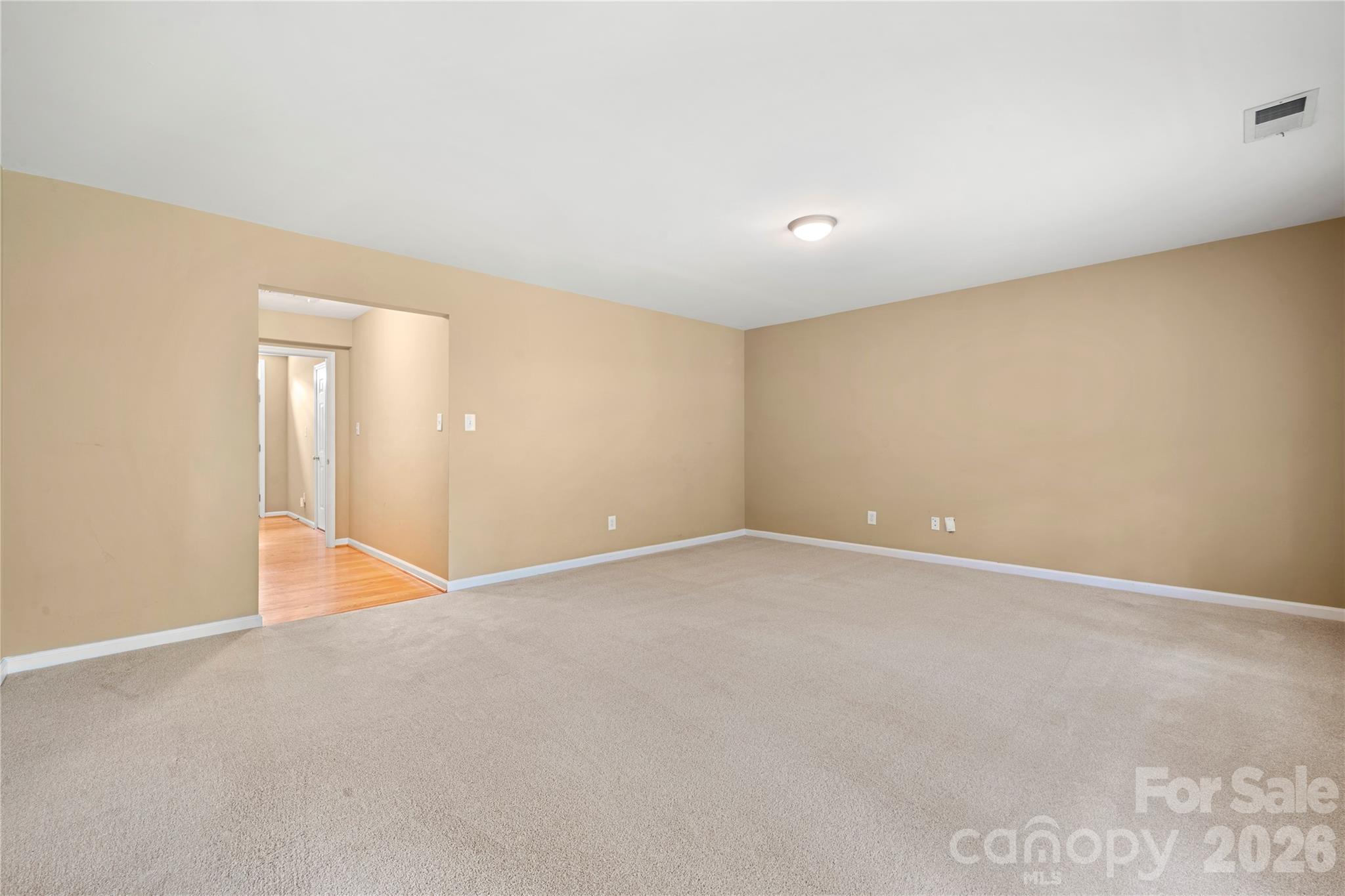 10213 Garrett Grigg Road Charlotte, NC 28262 - Photo 5 of 32 a view of an empty room with wooden floor