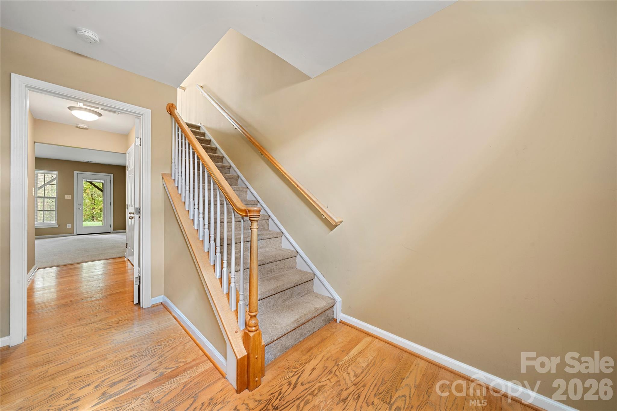 10213 Garrett Grigg Road Charlotte, NC 28262 - Photo 6 of 30 a view of a hallway with wooden floor and staircase