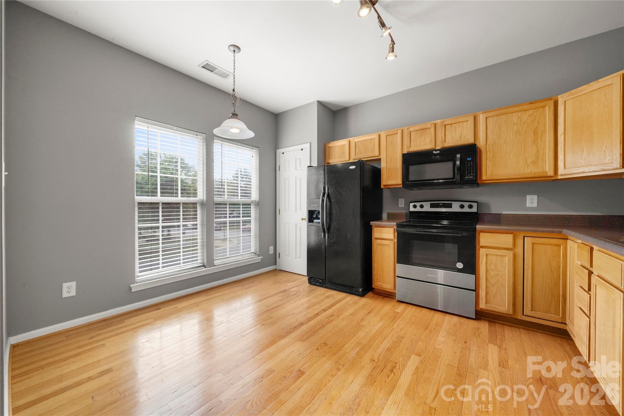 10213 Garrett Grigg Road Charlotte, NC 28262 - Photo 10 of 30 a kitchen with stainless steel appliances a stove sink and refrigerator