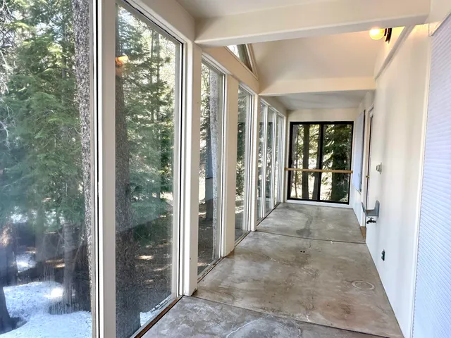 a view of a room with a large window and front door