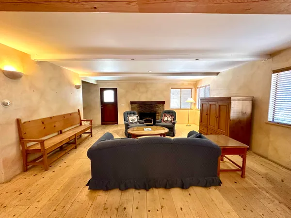 a living room with furniture fireplace and a flat screen tv
