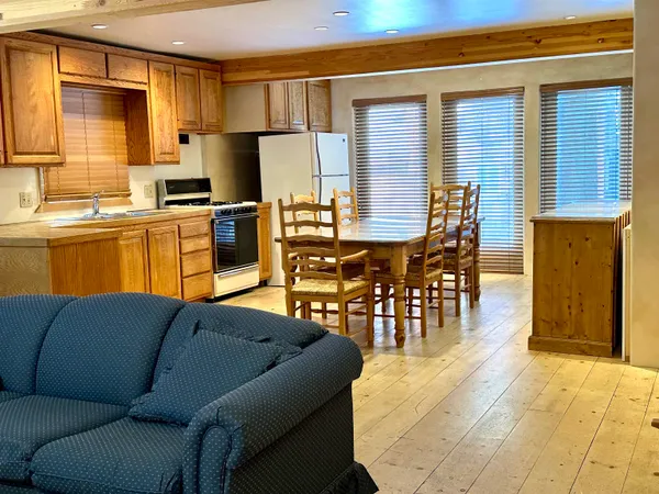 a living room with stainless steel appliances kitchen island granite countertop furniture and a kitchen view