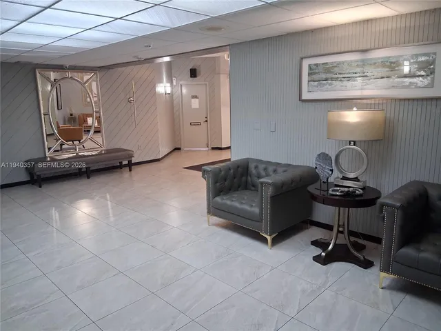 a living room with furniture and a lamp