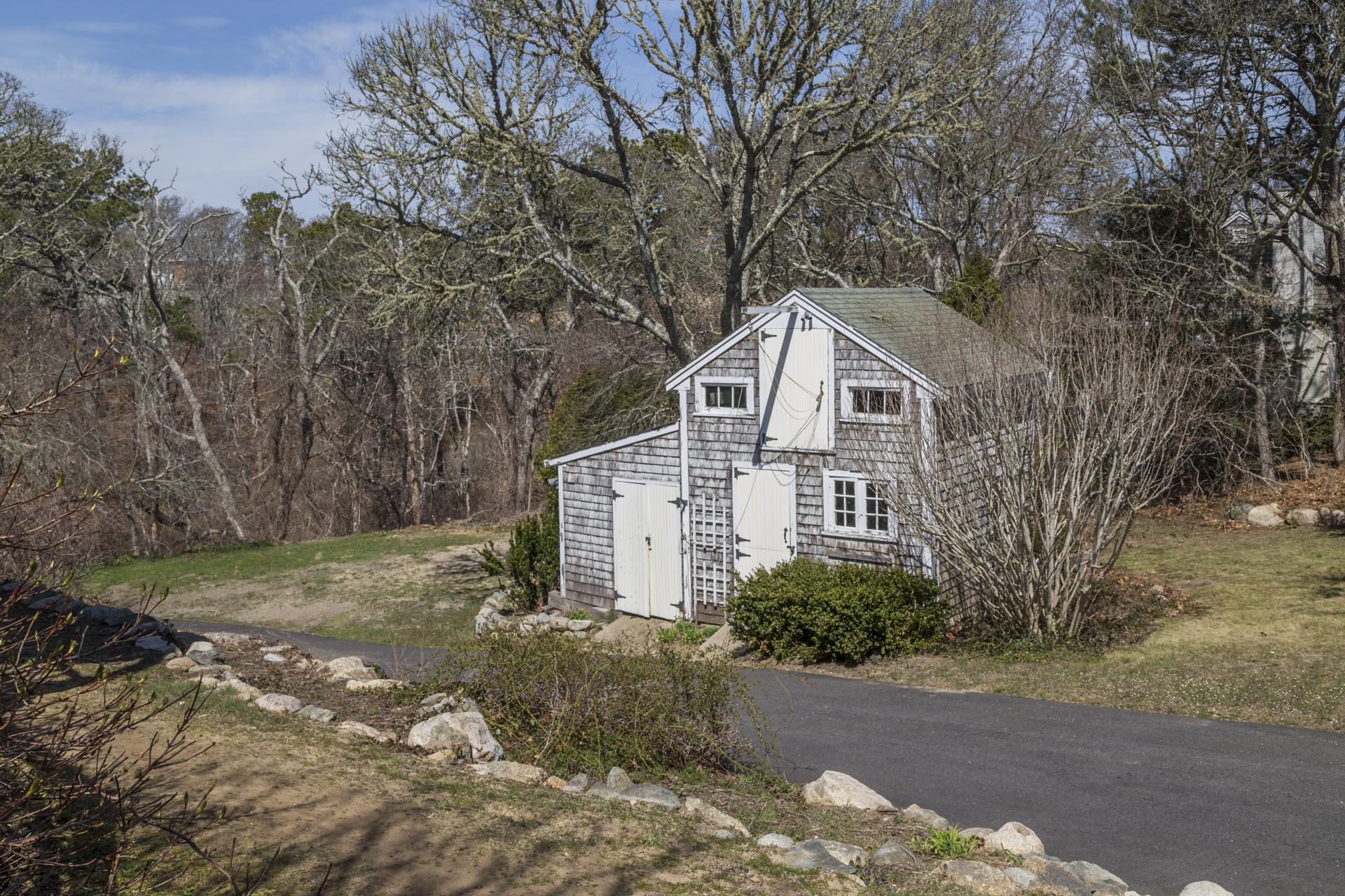 2118 Main Street Chatham, MA 02633 - Photo 7 of 33 a front view of a house with a yard and trees