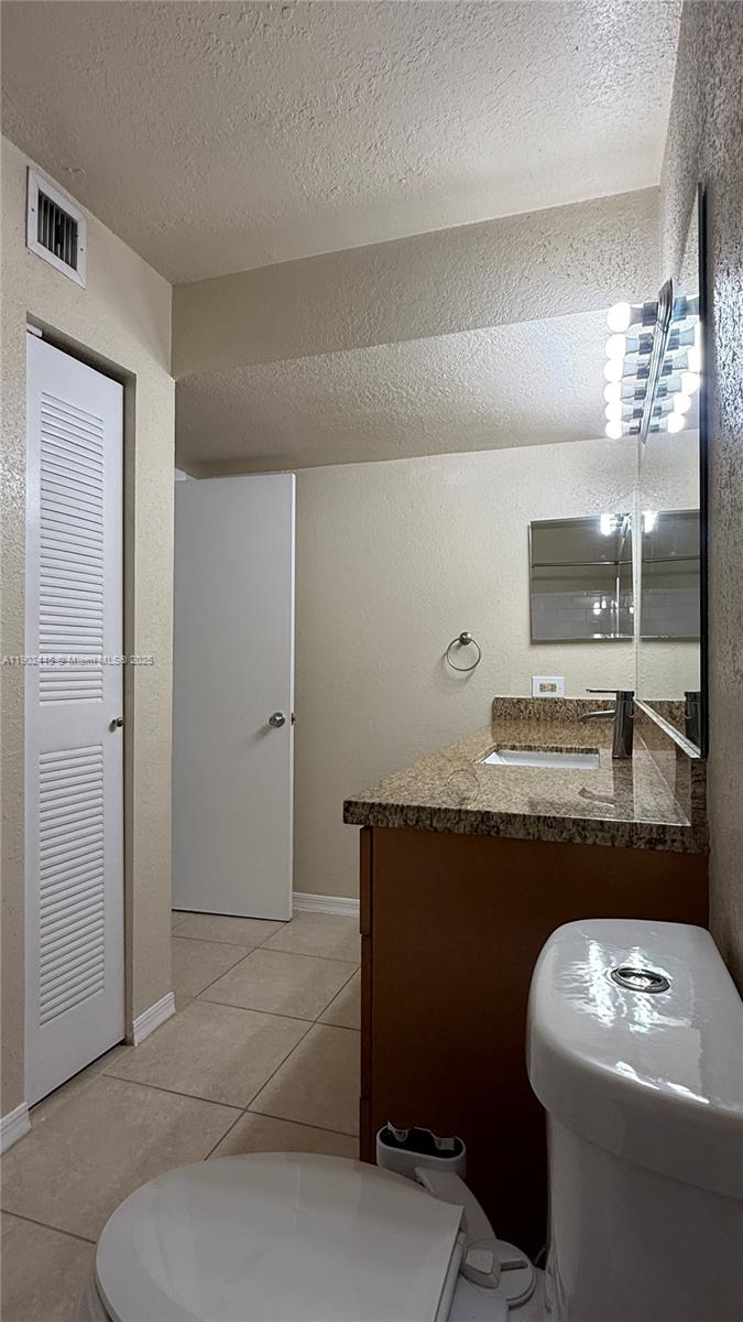 3470 Pinewalk Drive North, Unit 224 Margate, FL 33063 - Photo 11 of 24 a bathroom with a sink a toilet and a mirror