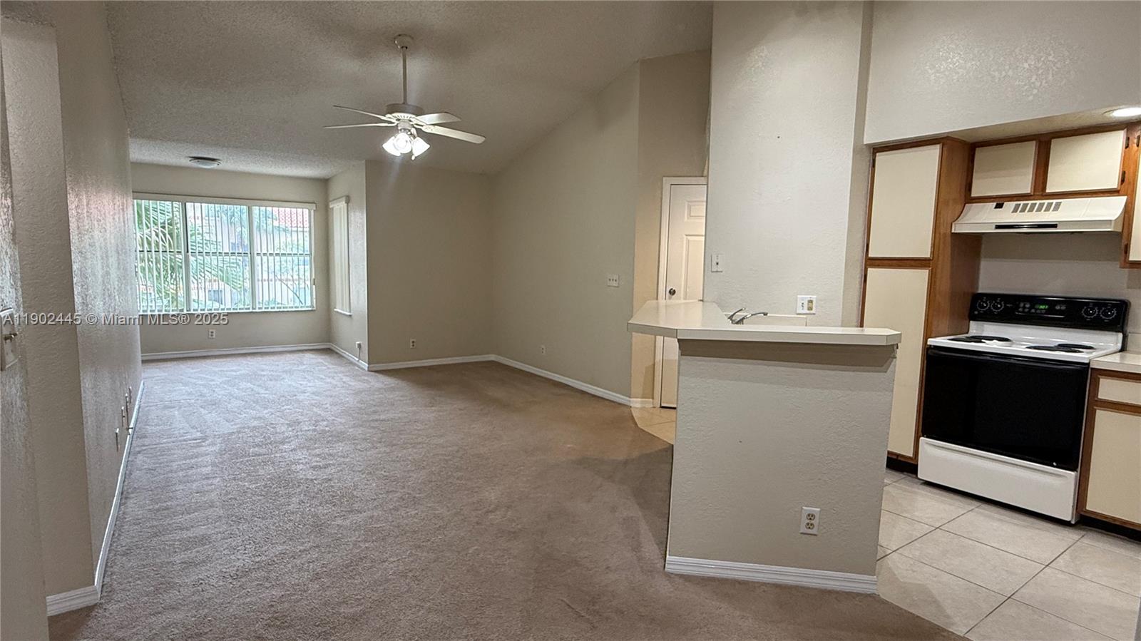 3470 Pinewalk Drive North, Unit 224 Margate, FL 33063 - Photo 2 of 24 a room with a stove and a microwave
