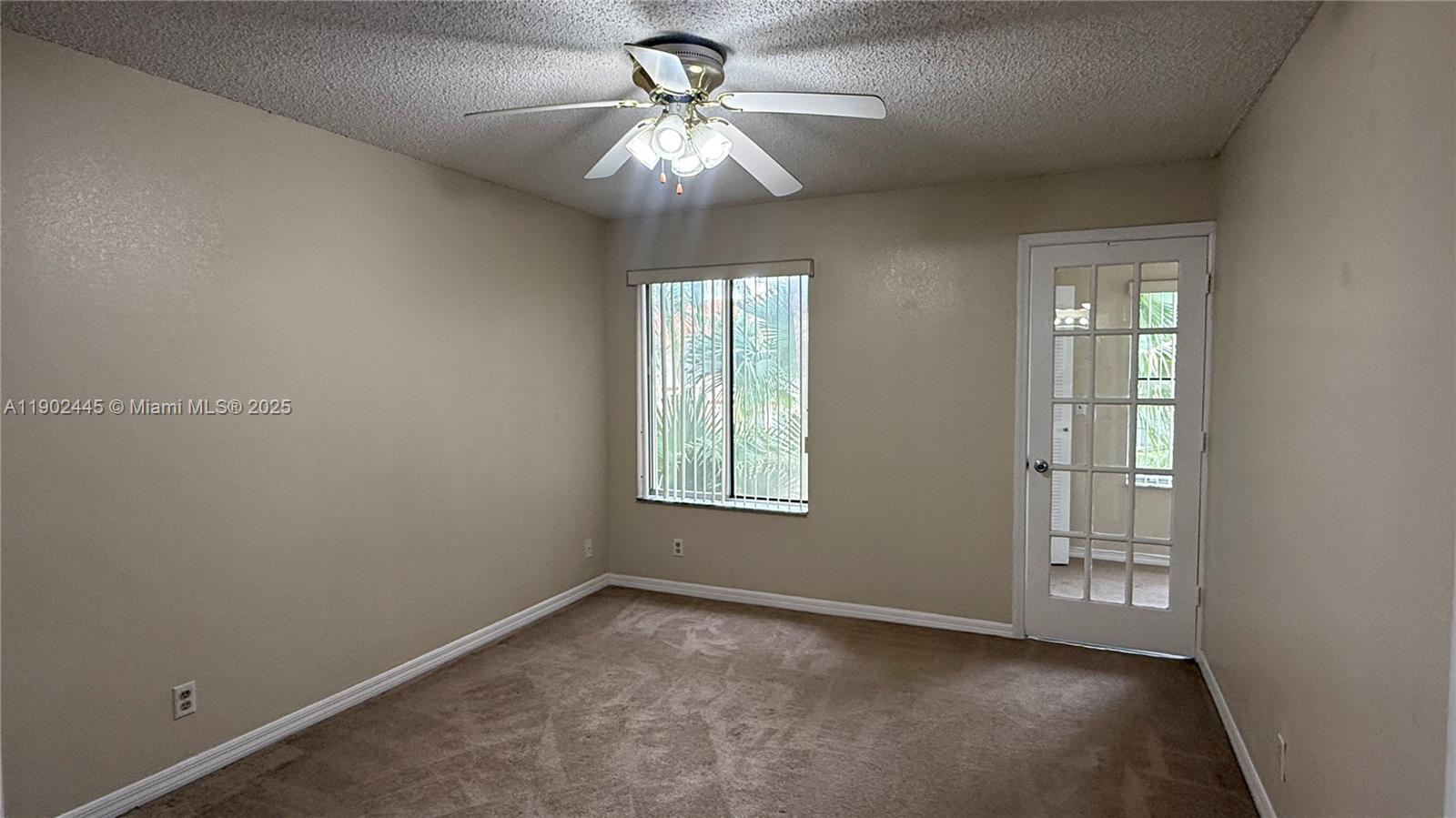 3470 Pinewalk Drive North, Unit 224 Margate, FL 33063 - Photo 8 of 24 an empty room with windows and chandelier fan