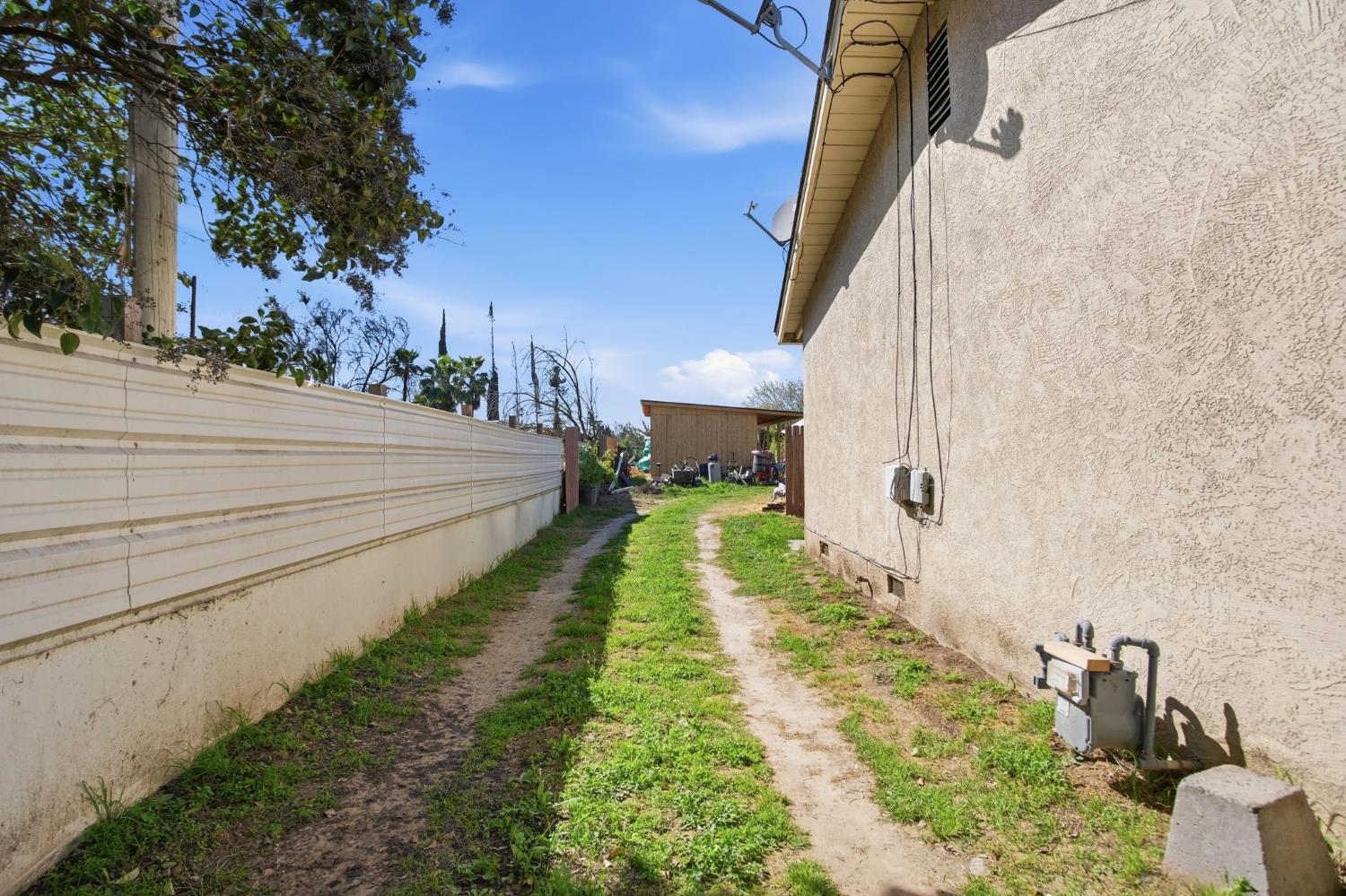 1409 Stonum Road Modesto, CA 95351 - Photo 27 of 40 a view of a pathway of a house with a yard