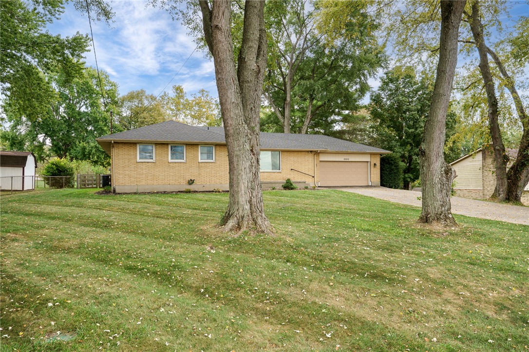 6950 Red Lion 5 Points Road Springboro, OH 45066 - Photo 6 of 78 This charming home features a classic brick exterior and an inviting yard with mature trees.