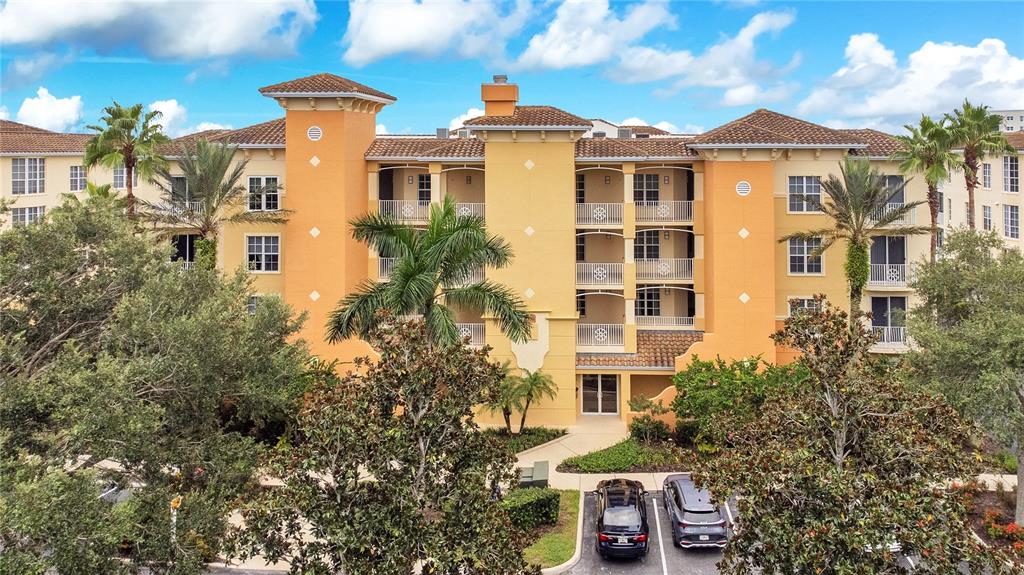 6350 Water Crest Way, Unit 203 Lakewood Ranch, FL 34202 - Photo 1 of 45 a front view of a multi story residential apartment building with a yard