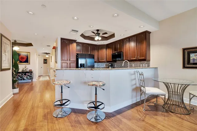 a view of a kitchen with dining table appliances and wooden floor