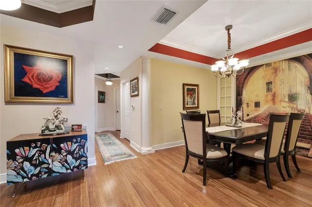 a view of a dining room with furniture and chandelier
