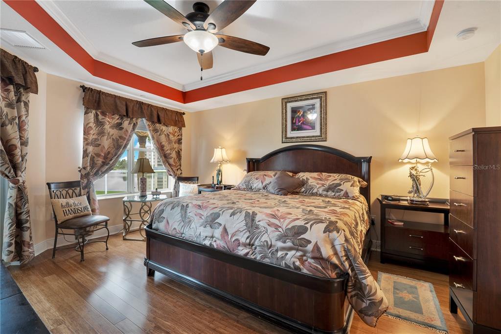 6350 Water Crest Way, Unit 203 Lakewood Ranch, FL 34202 - Photo 15 of 45 a bedroom with a bed and wooden floor