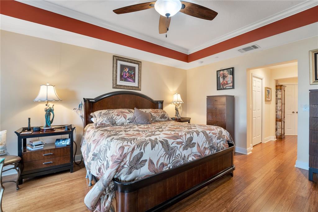 6350 Water Crest Way, Unit 203 Lakewood Ranch, FL 34202 - Photo 16 of 45 a bedroom with a bed and a chandelier