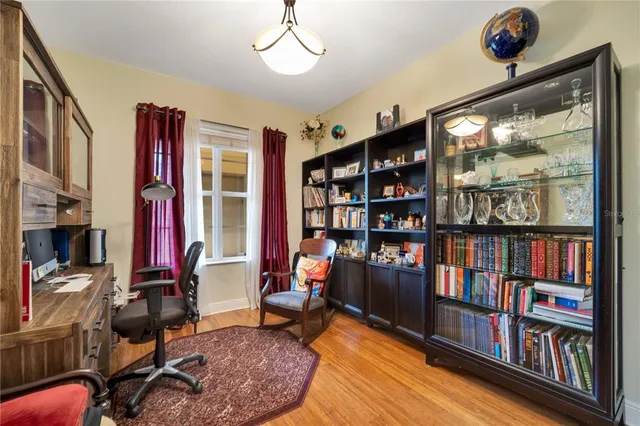 a living room with furniture a bookshelf and a window
