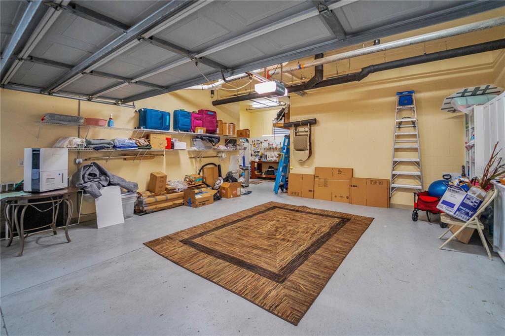 6350 Water Crest Way, Unit 203 Lakewood Ranch, FL 34202 - Photo 30 of 45 a living room with lots of furniture and gym equipment