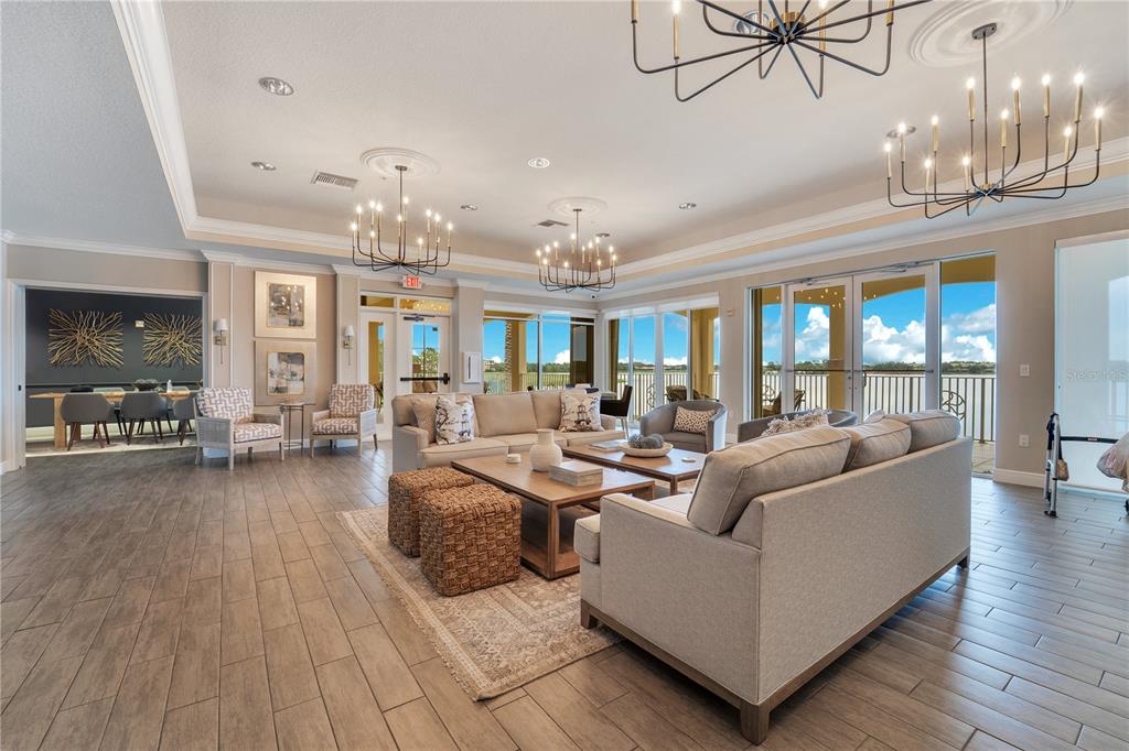 6350 Water Crest Way, Unit 203 Lakewood Ranch, FL 34202 - Photo 31 of 45 a living room with fireplace furniture and a chandelier