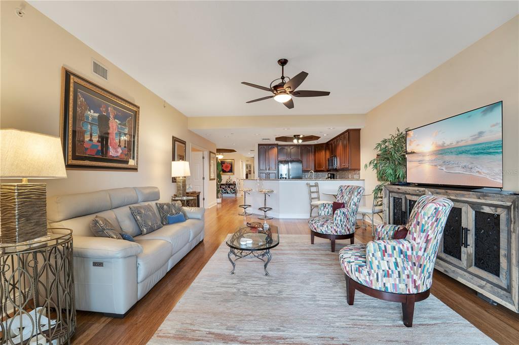6350 Water Crest Way, Unit 203 Lakewood Ranch, FL 34202 - Photo 7 of 45 a living room with furniture and a flat screen tv