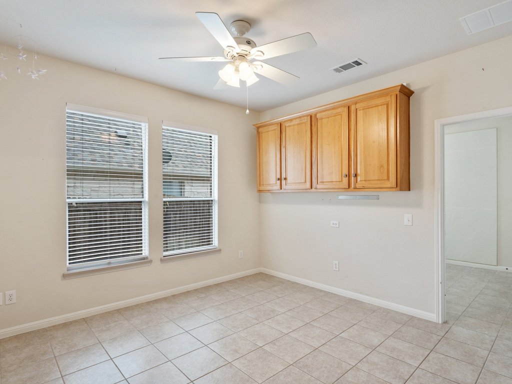1858 Nelson Ranch Loop Cedar Park, TX 78613 - Photo 13 of 32 Empty room with ceiling fan and light tile patterned floors