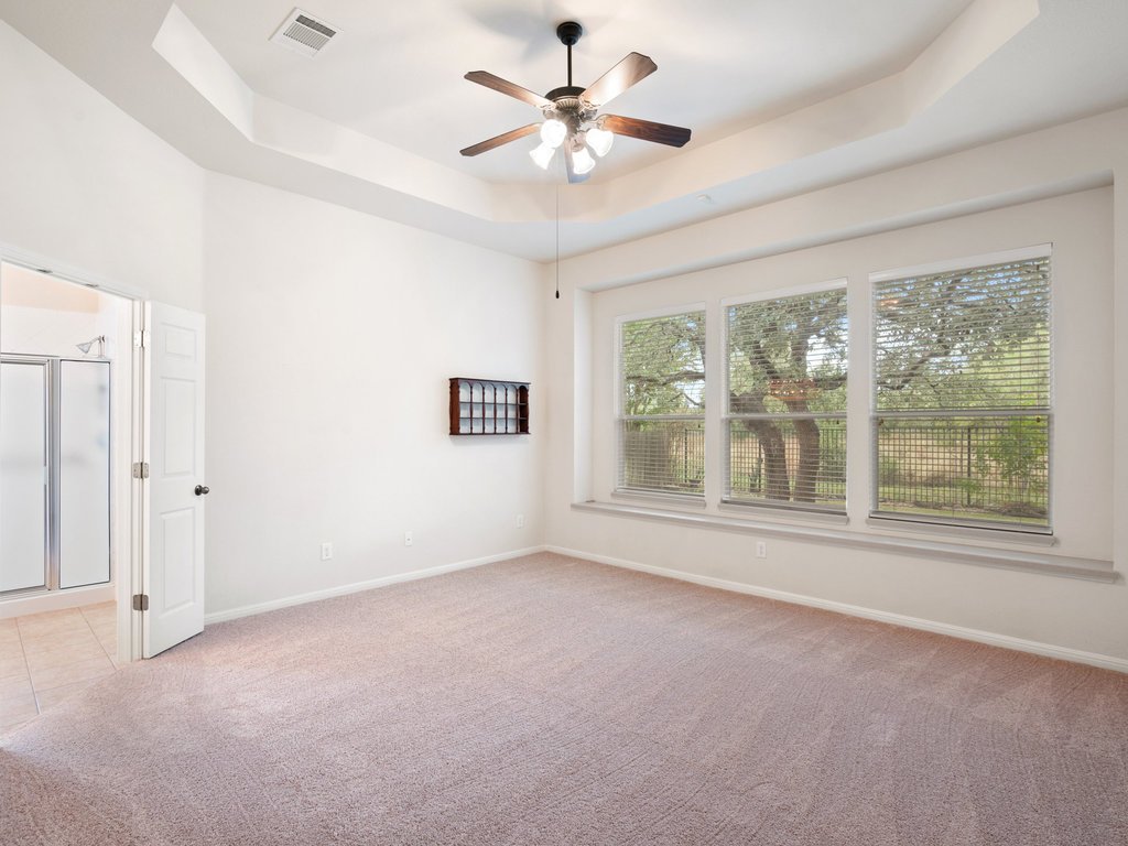 1858 Nelson Ranch Loop Cedar Park, TX 78613 - Photo 22 of 32 Empty room featuring a raised ceiling, light colored carpet, and a ceiling fan